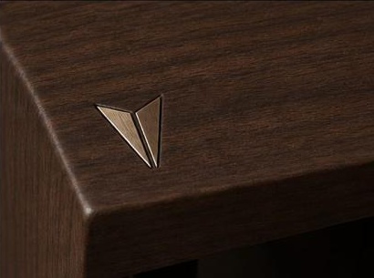 Bronze Viloya mark inlaid into a walnut table corner